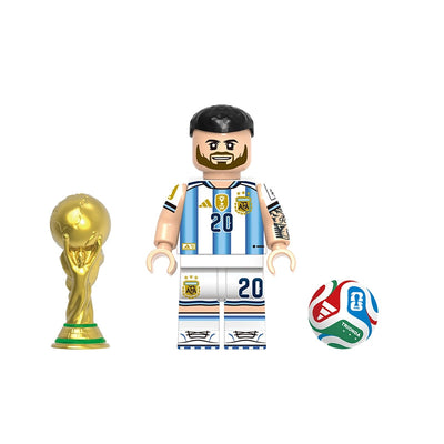 A soccer-themed minifigure set labeled 'MAC ALLISTER' with the code 'GH0808' at the top. The set includes a soccer player figure wearing a light blue and white Argentina jersey with the number 20, a gold FIFA World Cup trophy, and a multicolor soccer ball on a plain white background.