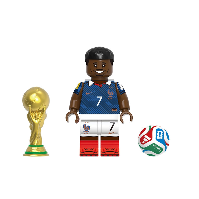 A soccer-themed toy minifigure labeled Dembélé, shown with a gold FIFA trophy on the left and a multicolor soccer ball on the right, on a plain white background. A gray label at the top reads GHO830.