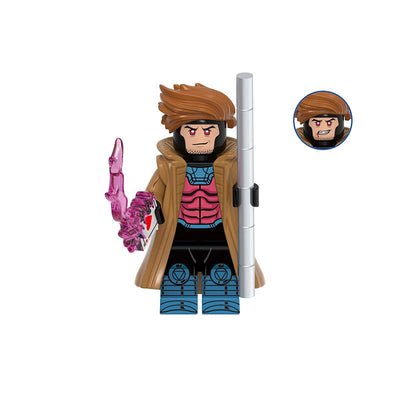 A toy minifigure labeled 'Gambit' with the code 'GHO944' above it on a plain white background. The figure has brown hair, a tan coat, black and blue bodysuit, and holds a pink translucent weapon and a silver pole.