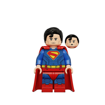 Superman toy building block minifigure with a red cape, blue textured suit, yellow belt, and red chest emblem, shown on a white background with a small inset of an alternate face and text reading K2401 Superman.