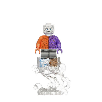 A custom toy minifigure labeled 'K2402 Metamorpho' on a white background. The figure has a gray head with blue eyes, a split orange and purple torso, black pants, and stands on a clear, bubbly transparent base.