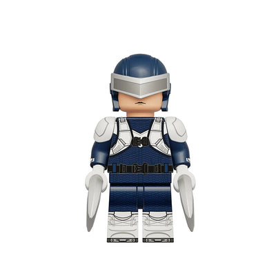 A toy minifigure of Boomerang from the Marvel Cinematic Universe, designed in a building block style. The figure features a dark blue helmet with a silver visor, a blue and white armored chest plate, and matching blue and white pants, with two silver blades extending from the hands.