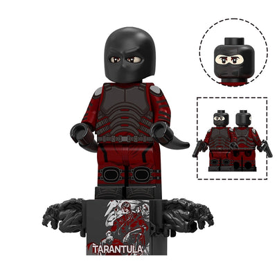 A building block minifigure of Tarantula from Marvel, featuring a black mask, red and black armored suit, and holding black weapons, displayed on a black stand with two wolf heads. Includes inset images of the head and a pair of hands, with text 'TV1304 Tarantula' on a white background.
